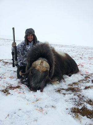 Hunter with dead musk ox