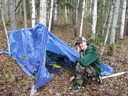 Youth setting up a tent with a tarp