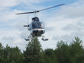a helicopter is flown over the creek to assess the salmon population from the sky