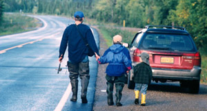 Fishing Family walking along road to their car