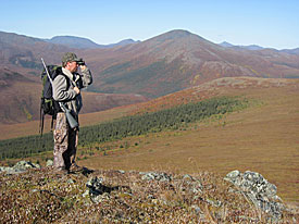 Photo of a man looking through a pair of binoculars